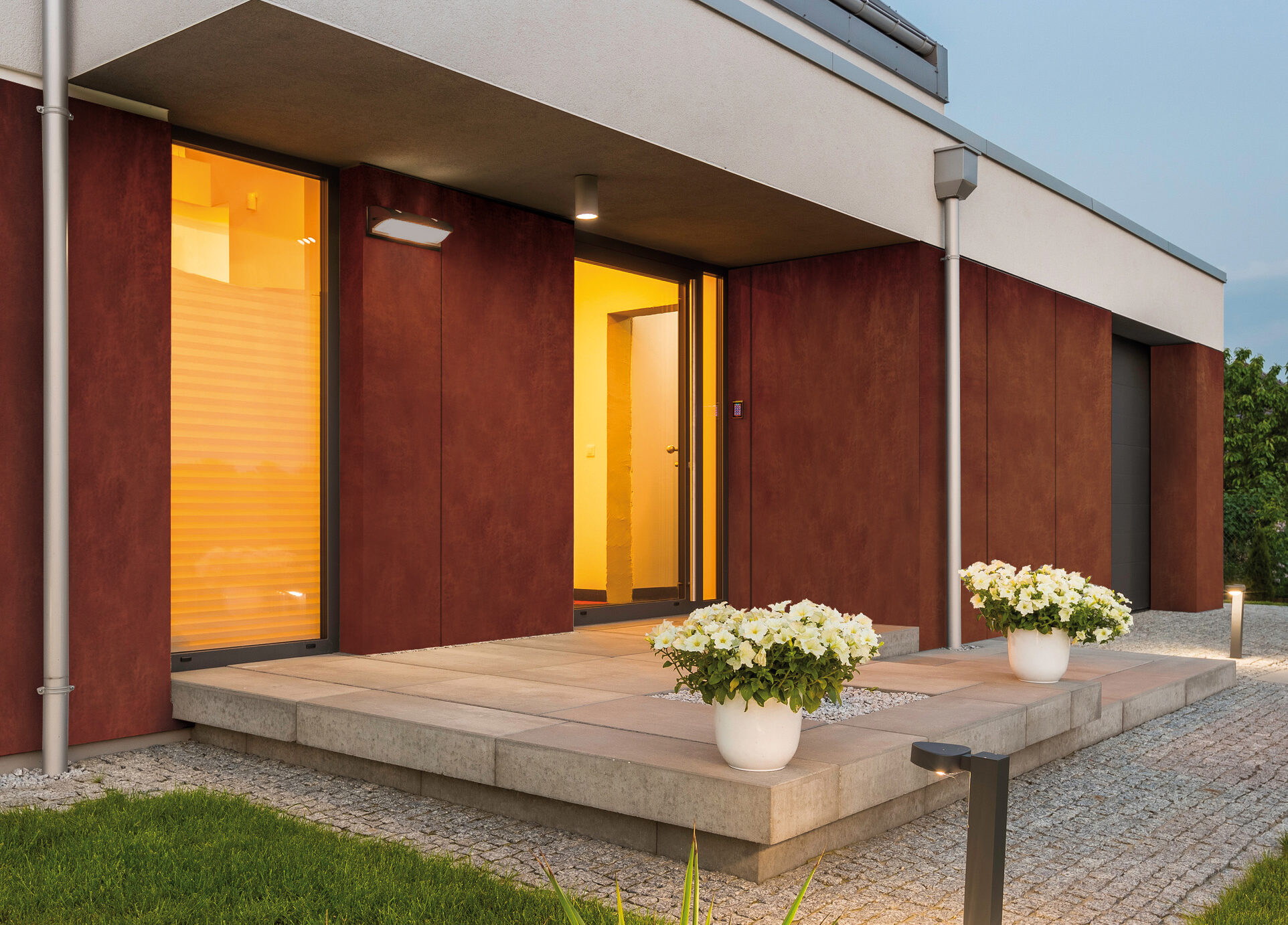 Modern house with nice lawn and surrounded by decorative outdoor lights